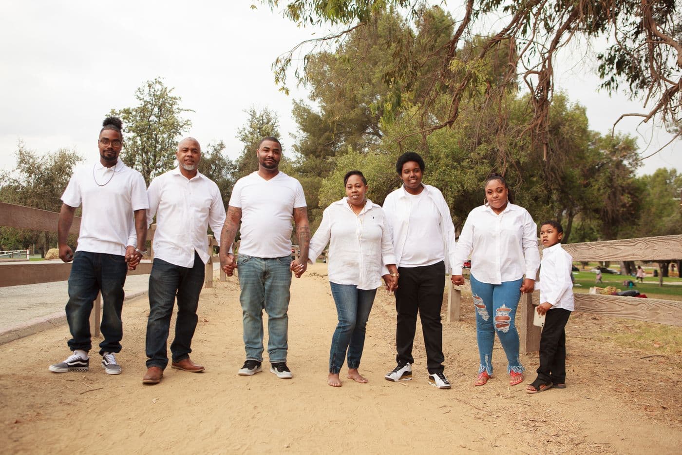 Family members holding hands together in a park